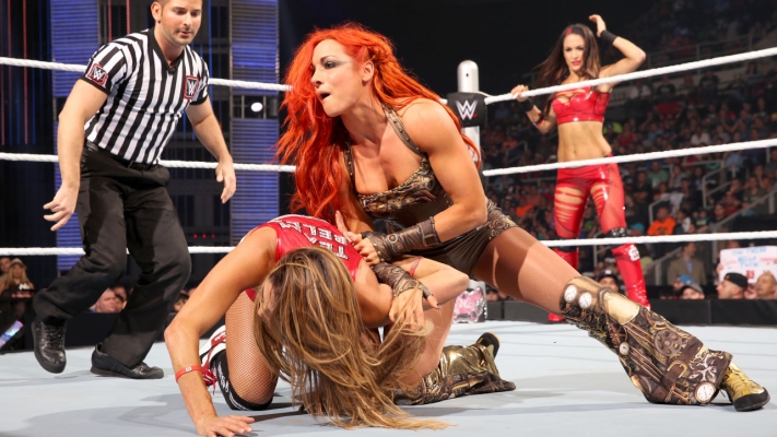 We go to the back where Charlotte and Becky Lynch are talking about somethi...
